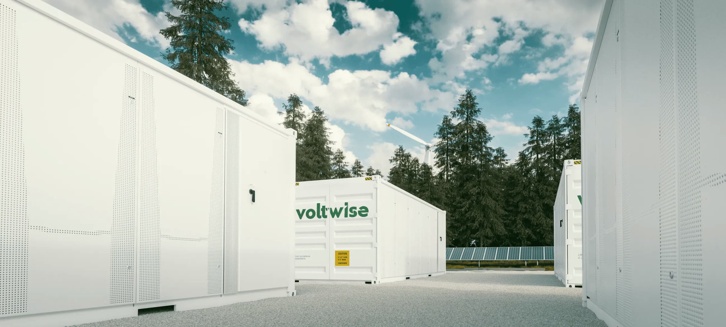 Voltwise battery energy storage containers among pine trees, with solar panels behind